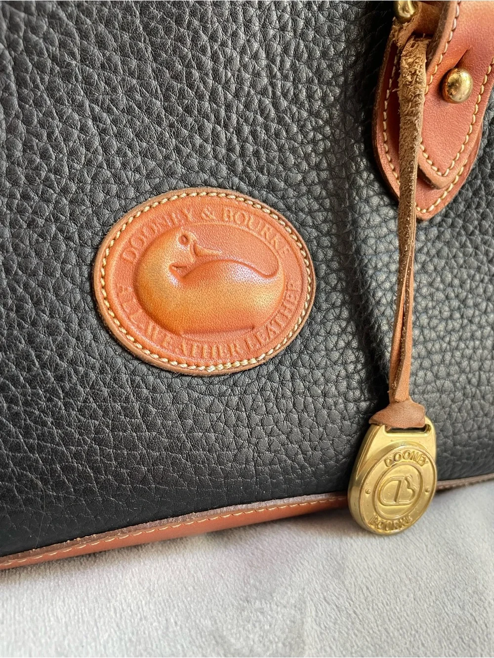 Dooney & Bourke Vintage All Weather Leather Handbag Black Tan Duck Logo AWL